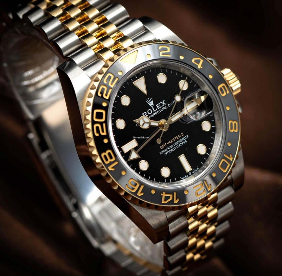 2024 Rolex GMT-Master II GRNR two-tone watch featuring black dial with gold accents and GMT bezel.