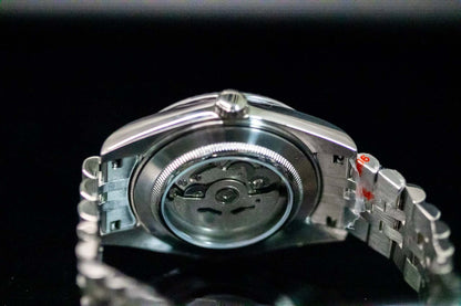 Back view of the blue SeikoMod Land Dweller watch showcasing its NH36 automatic movement and stainless steel strap.