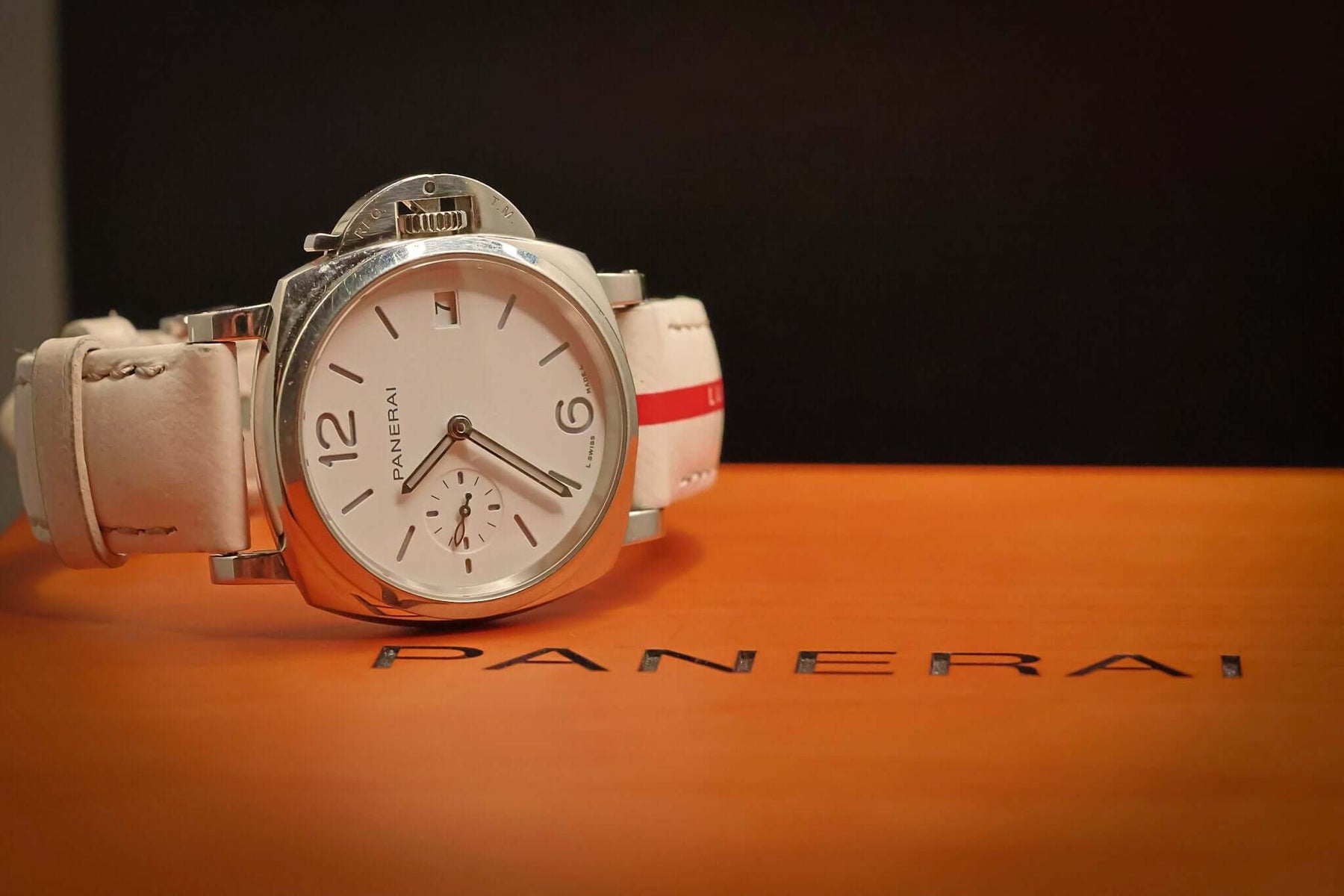 Panerai Luminor Submersible Luna Rossa PAM01306 – 38MM Stainless Steel Men’s Watch – Full Set on a stylish display.