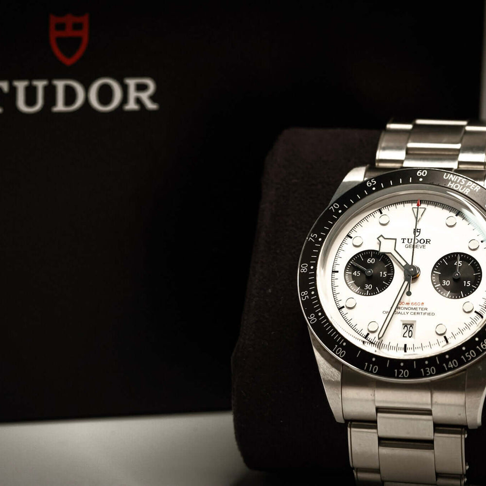 Tudor Black Bay Chronograph Panda displayed on a plush stand next to its distinctive black box.