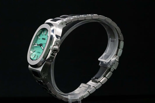 Angled shot of SeikoMod Tiffany Nautilus showcasing integrated bracelet and soft blue dial