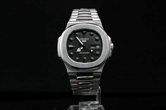 SeikoMod Black on Black Nautilus front view with black dial and integrated black case
