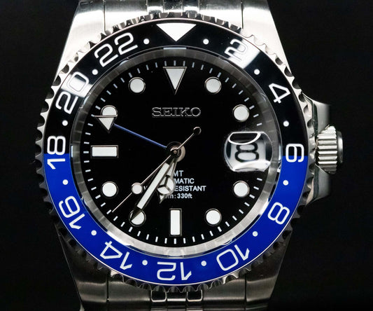 Close-up of SeikoMod Batgirl GMT dial with 24-hour markings and GMT hand