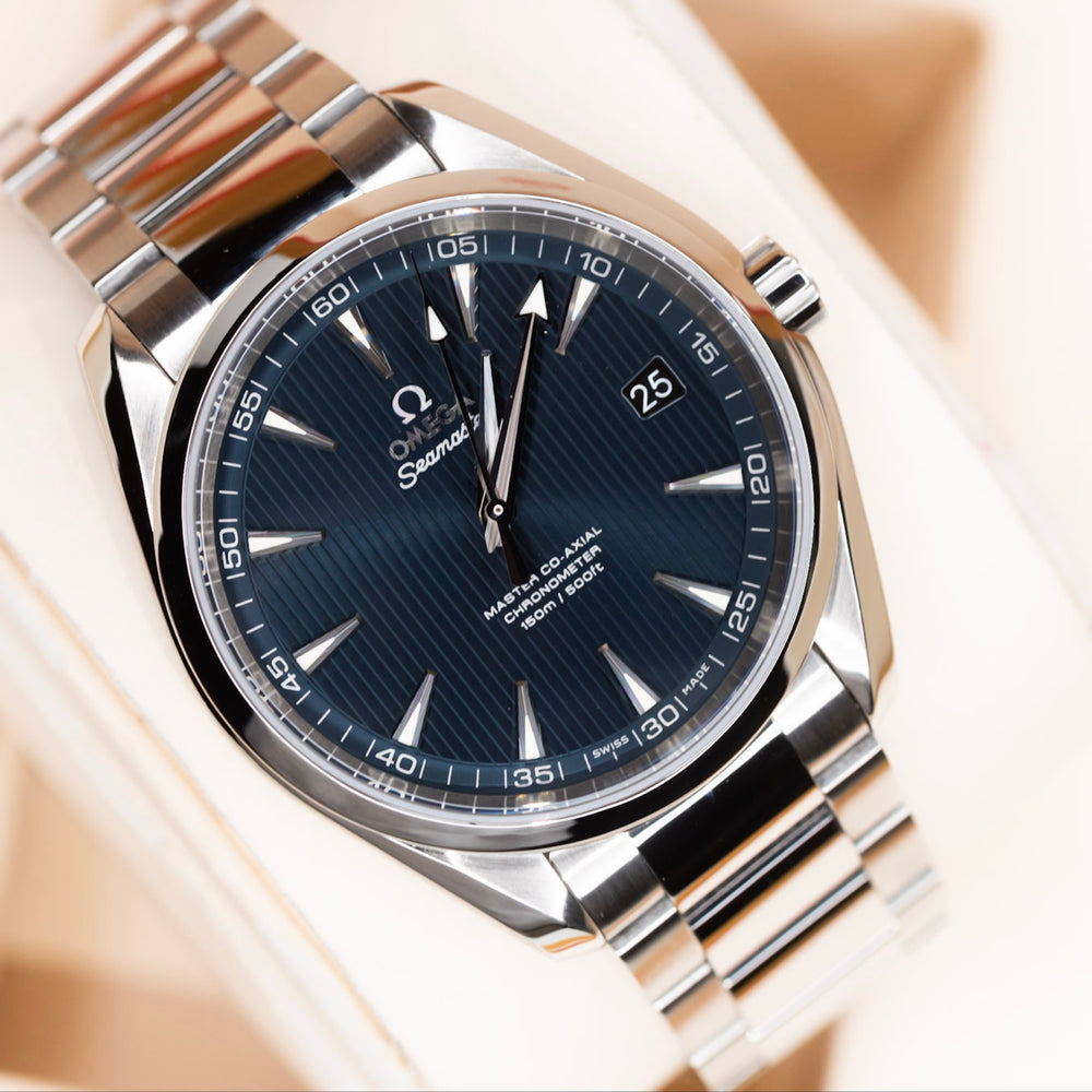 Close-up of Omega Seamaster Aqua Terra watch with blue Teak Concept dial and stainless steel bracelet.