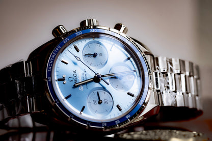 Omega Speedmaster Chronograph 38 review featuring blue dial and steel bracelet, automatic movement, showcased in detail.