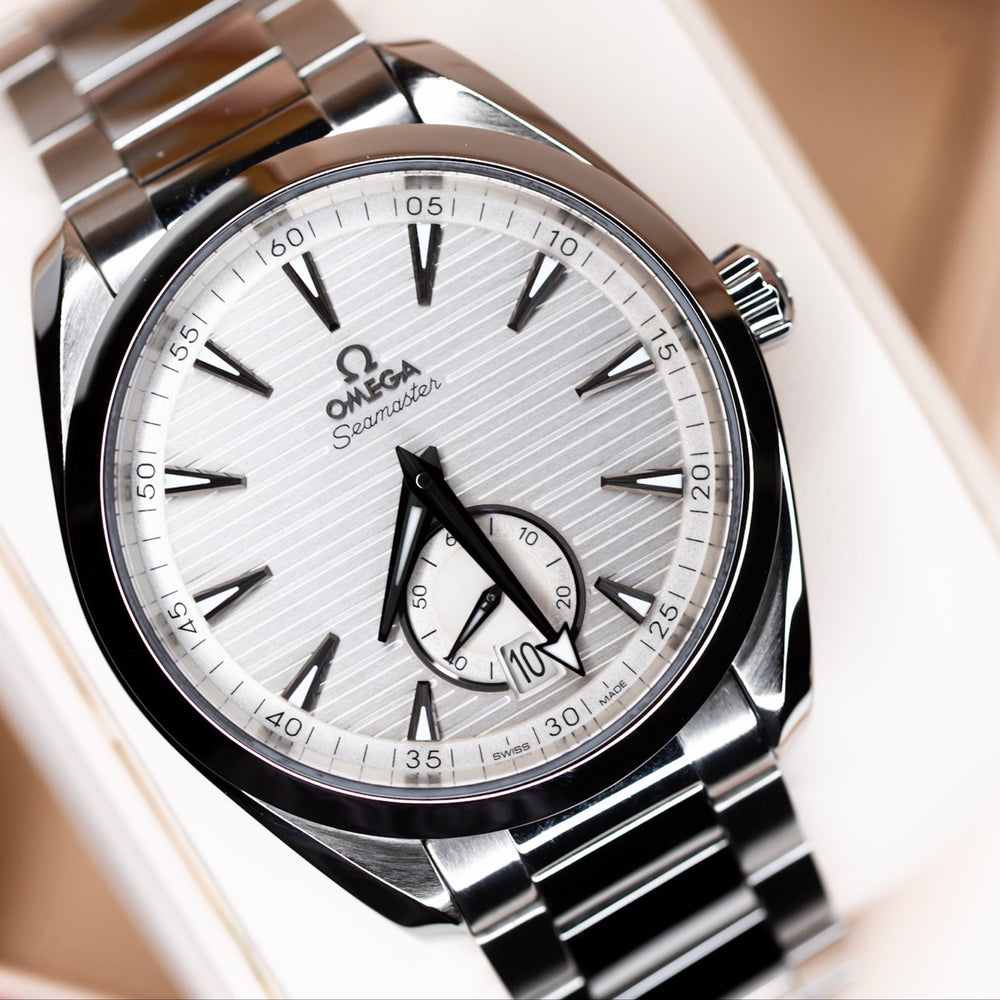 Omega Aqua Terra Small Seconds watch with silvery teak-pattern dial and blackened hands.