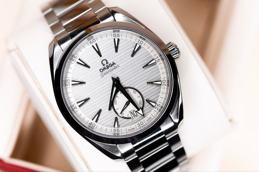 Omega Aqua Terra Small Seconds watch with silvery teak-pattern dial and blackened hands.