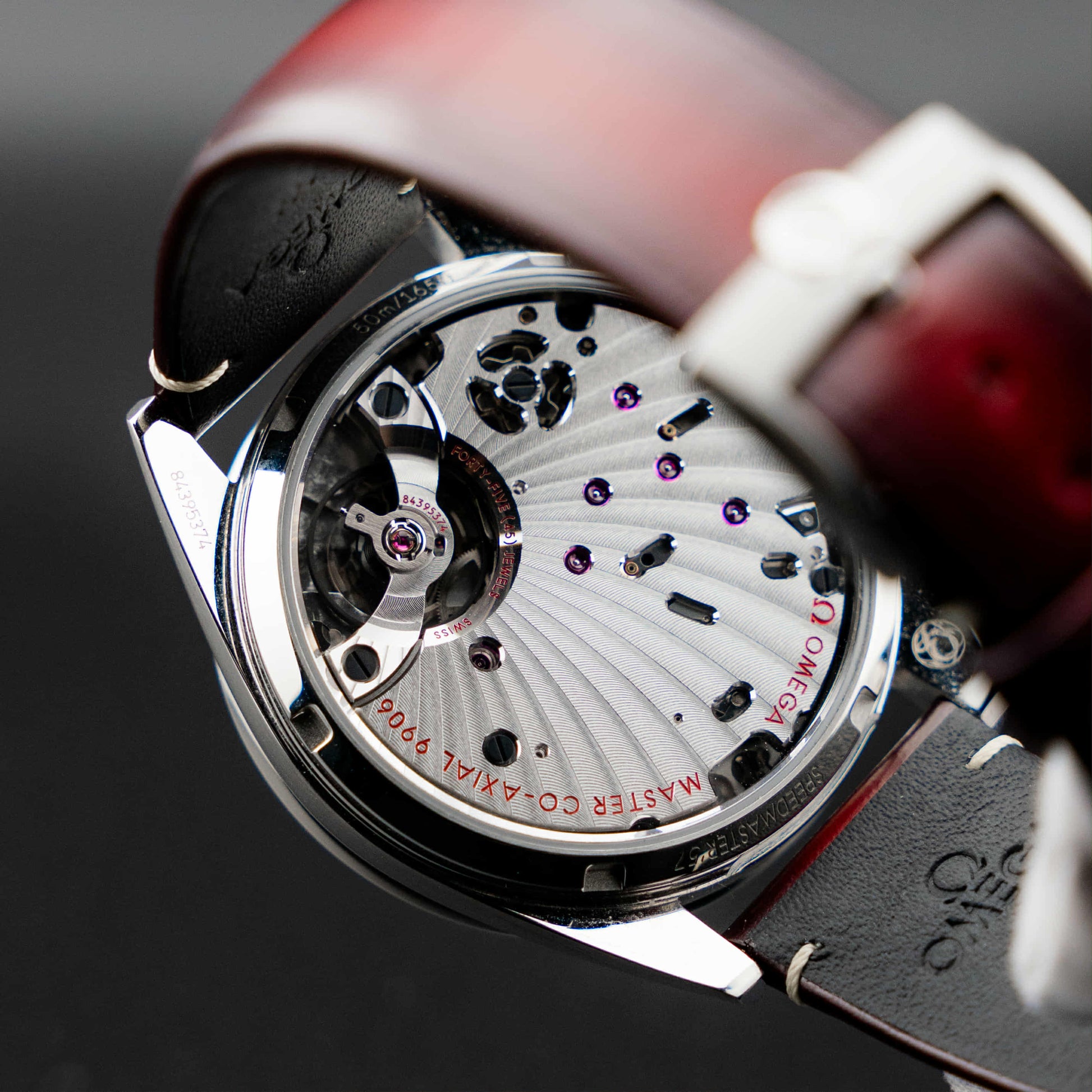 Omega Speedmaster '57 Burgundy full set watch movement rear view with manual-wind Co-Axial mechanism.
