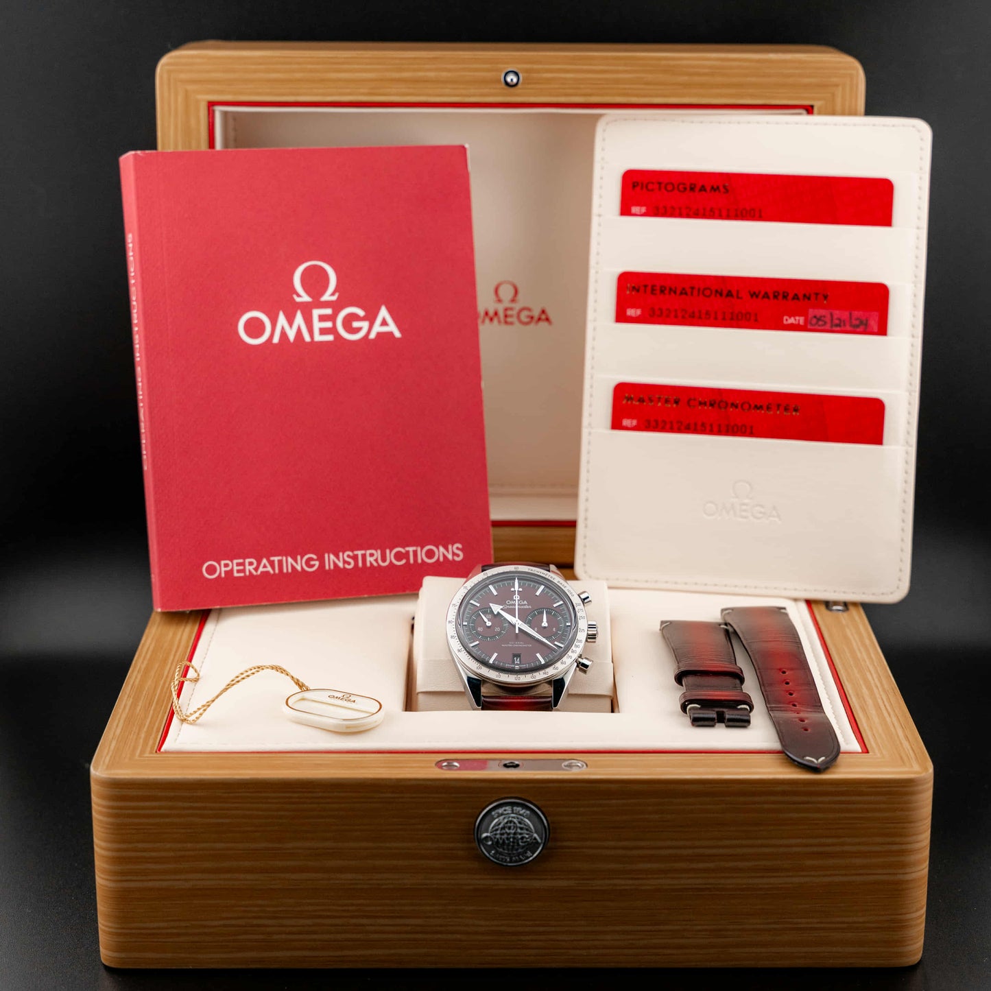 Omega Speedmaster '57 Burgundy full set in wooden box with operating instructions and accessories.
