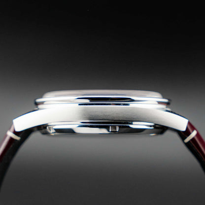 Omega Speedmaster '57 Burgundy full set side profile showing case and strap design.
