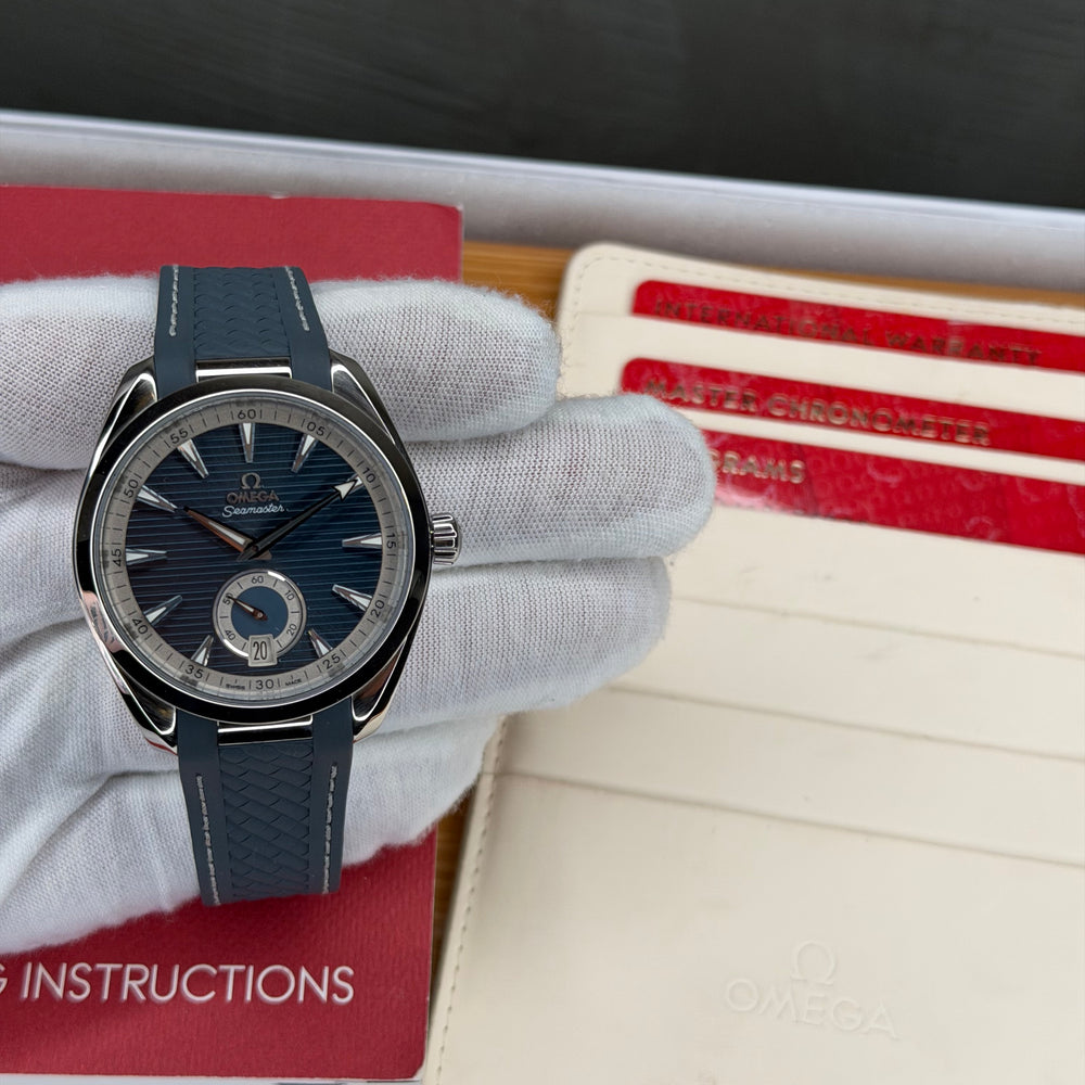 Omega Seamaster Aqua Terra 150M blue dial displayed with its full set instructions and warranty cards.