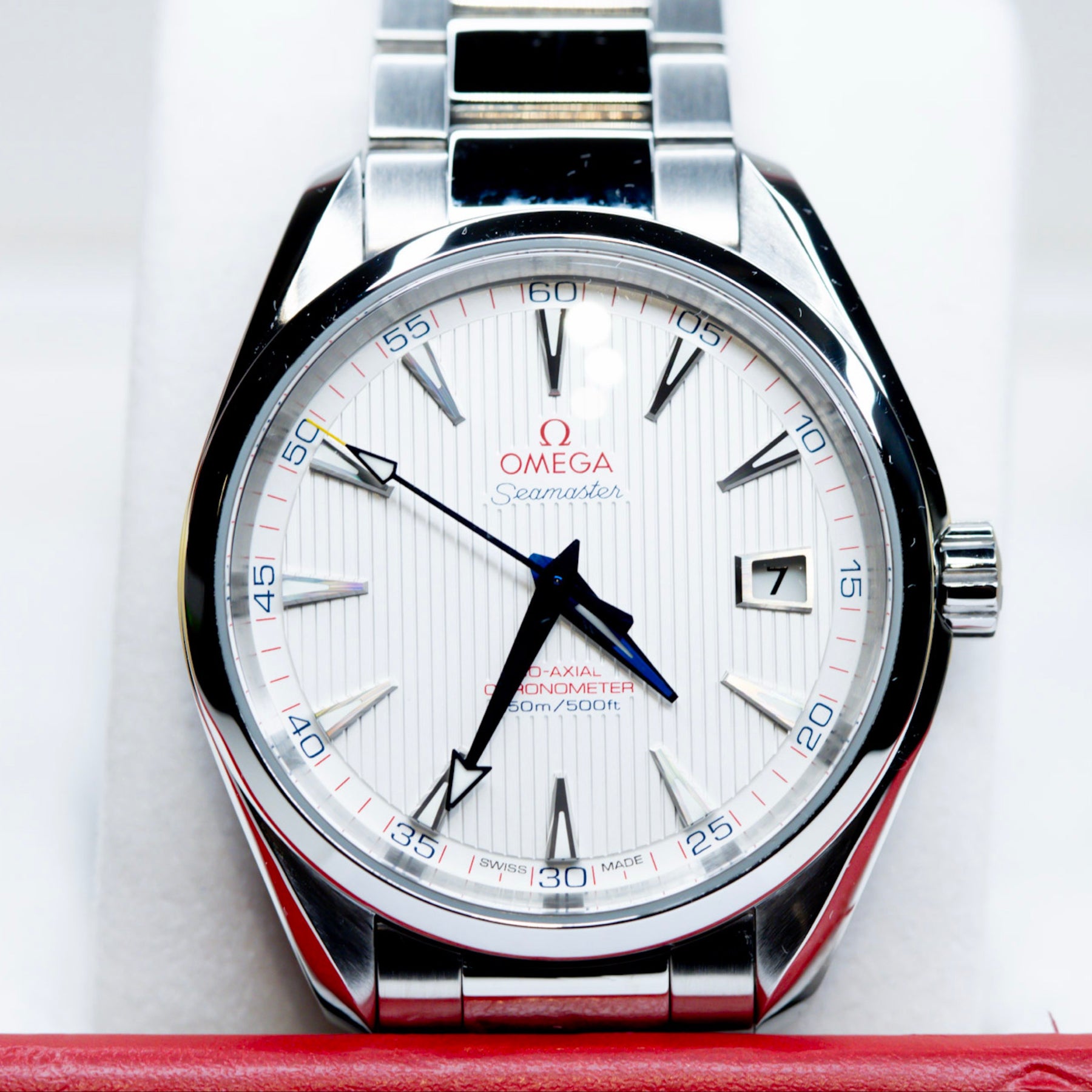2018 Omega Seamaster Aqua Terra watch featuring a bright opaline white-silver dial with blue hands and red accents.