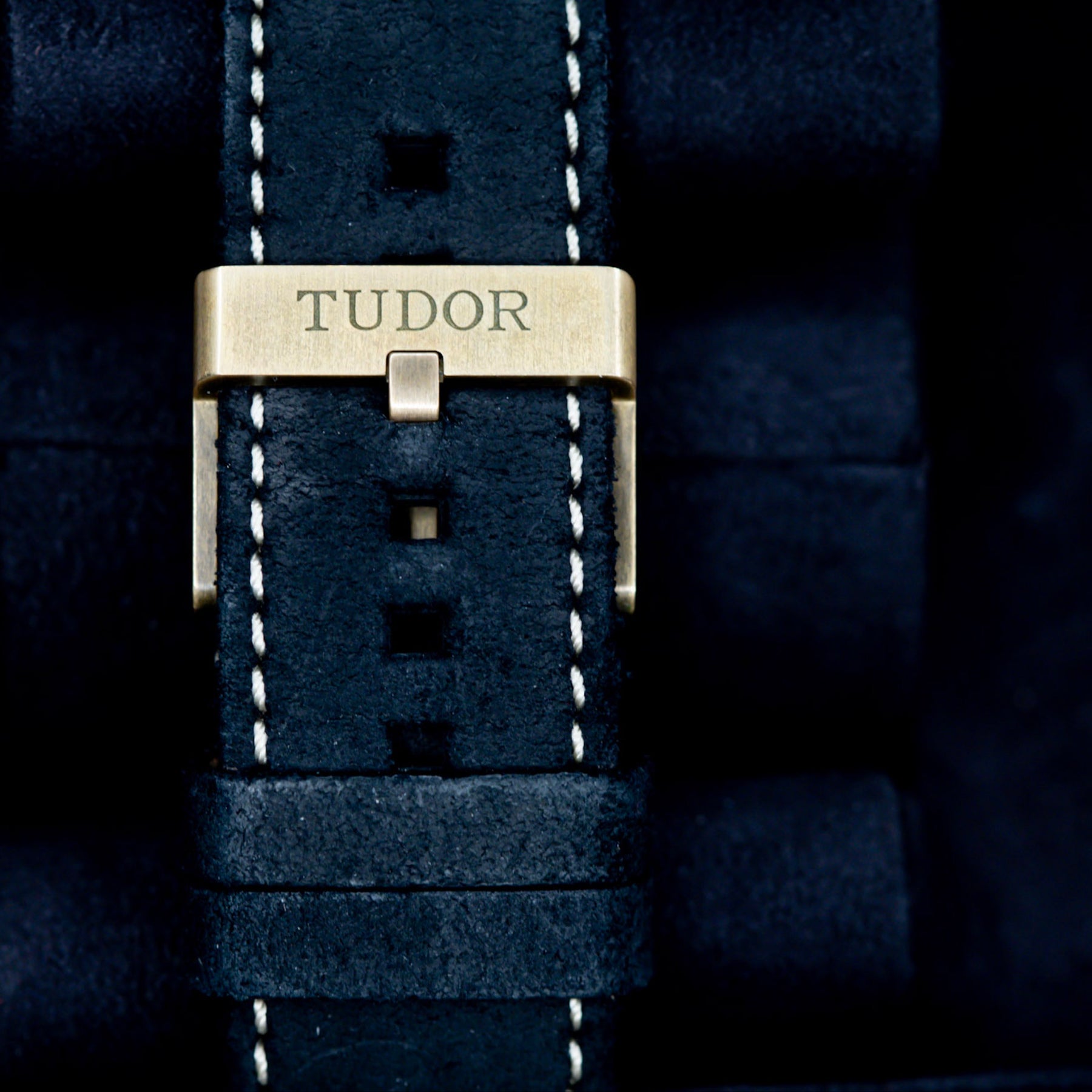 Close-up of the Tudor clasp on a black leather watch strap for the 2022 Tudor Black Bay Bronze watch.