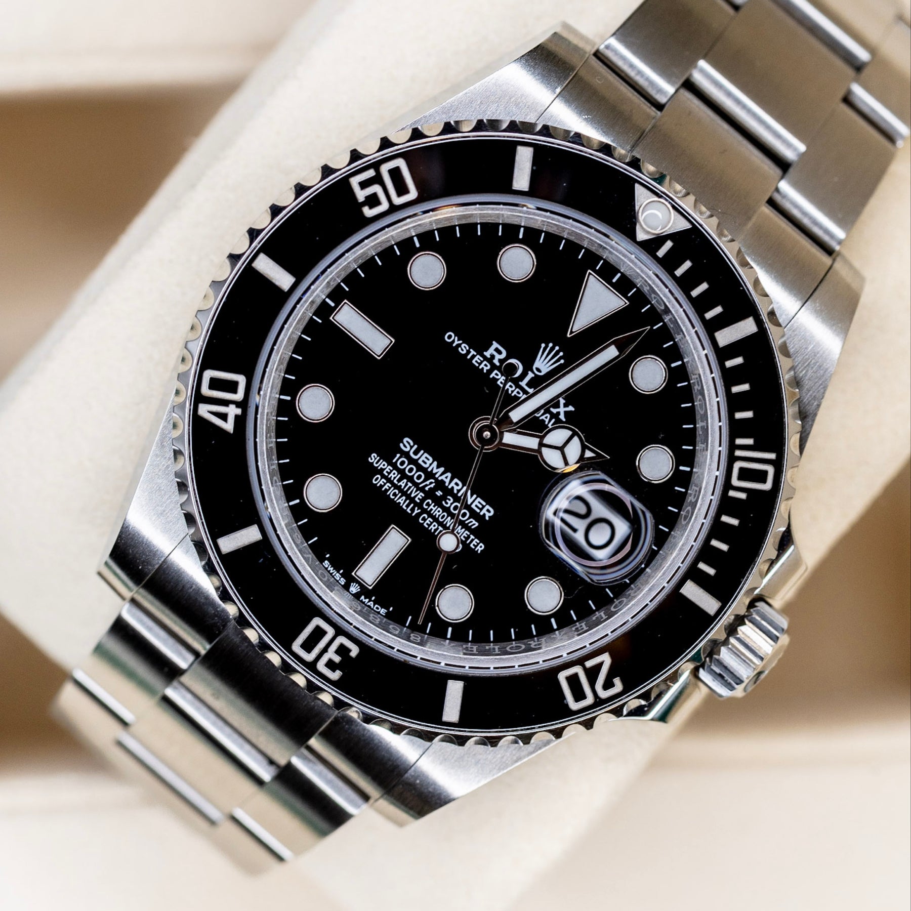 2025 Rolex Submariner Date black watch on display with stainless steel bracelet and black dial.