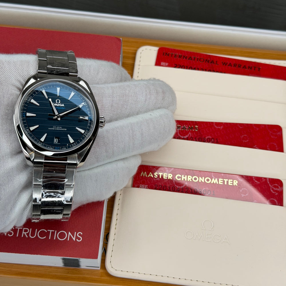 Omega Seamaster Aqua Terra 41mm watch displayed with international warranty and instructions.