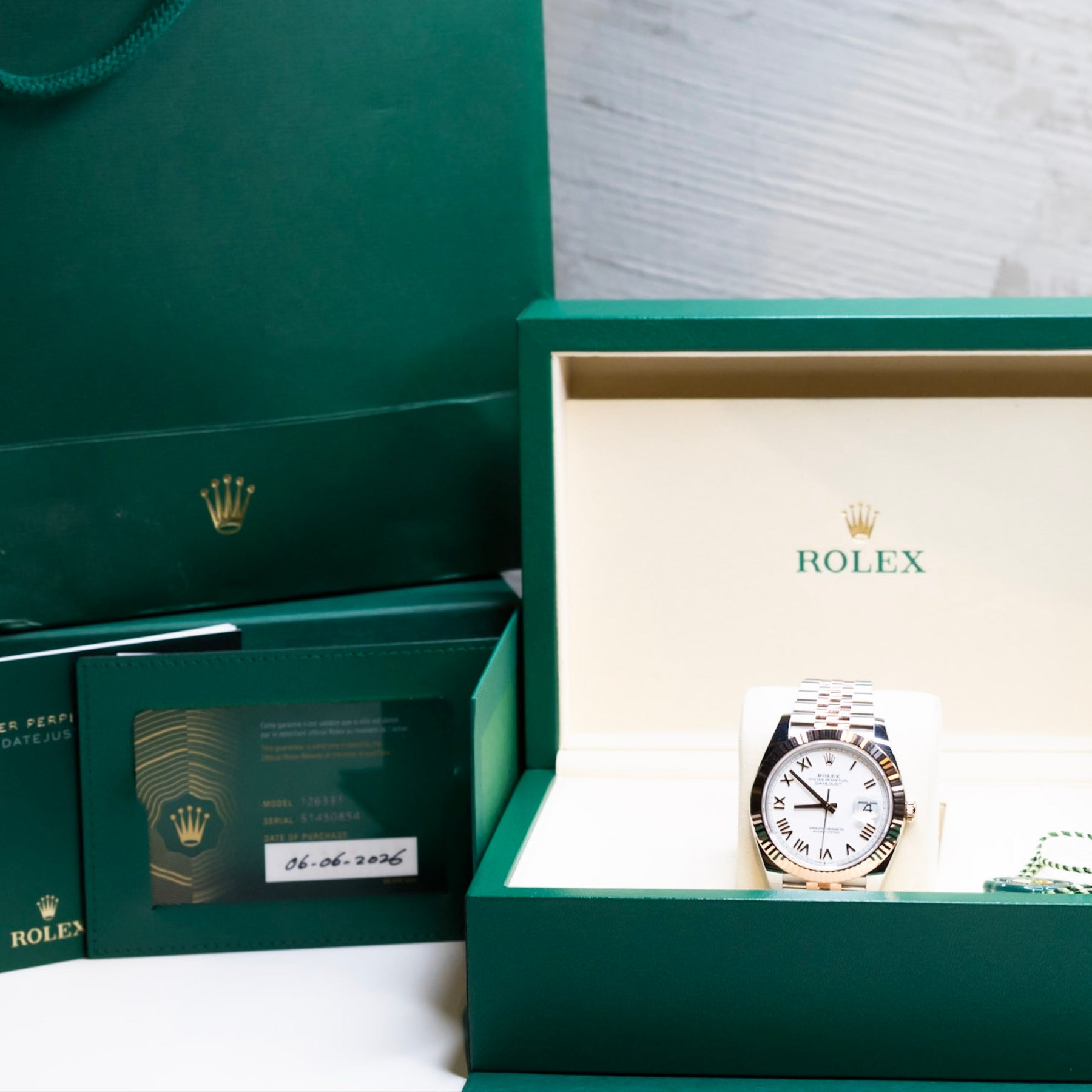2025 Rolex Datejust 41 rose gold watch in a green box and bag, showcasing its luxurious design and authenticity.