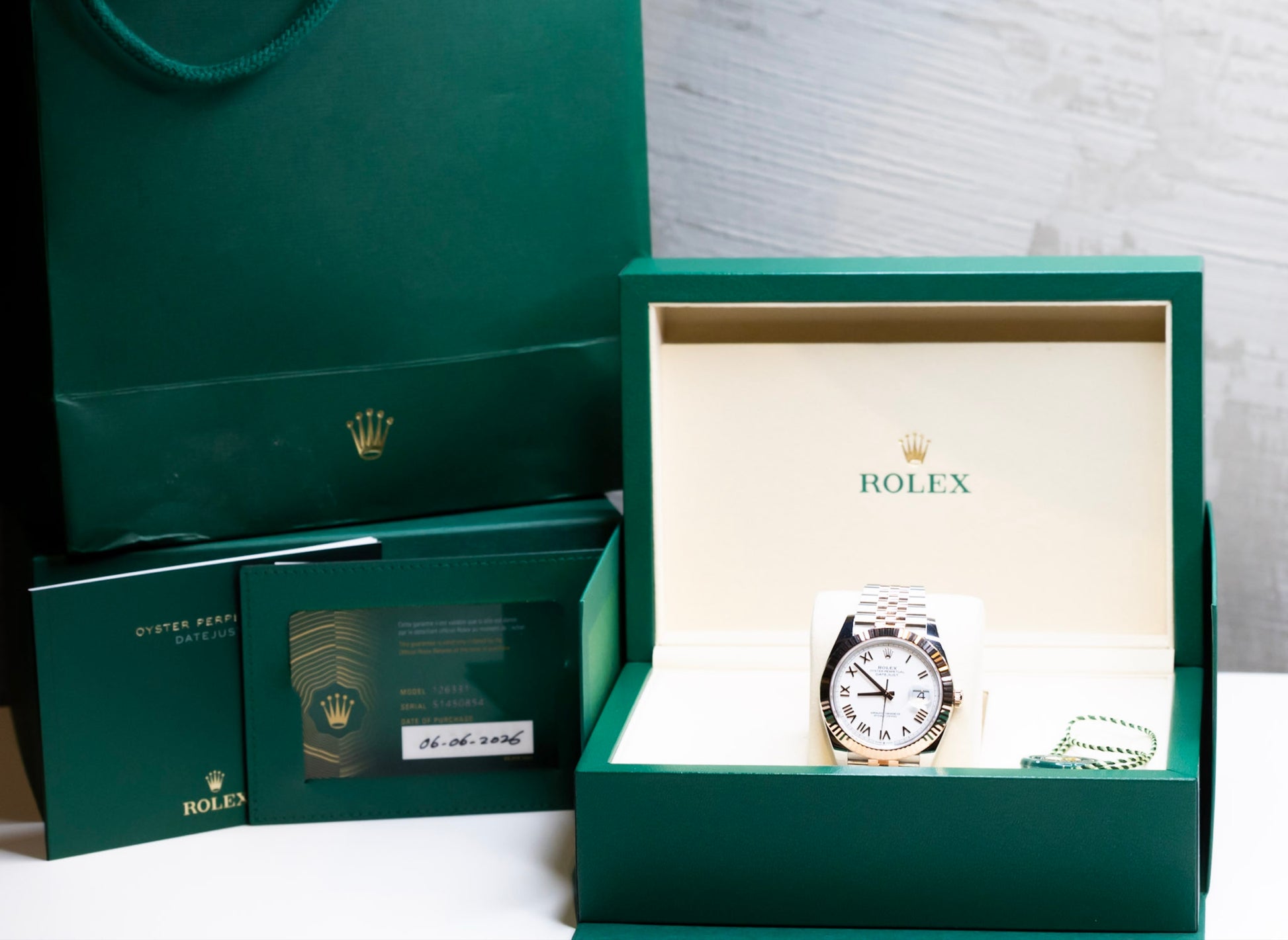 2025 Rolex Datejust 41 rose gold watch in a green box and bag, showcasing its luxurious design and authenticity.