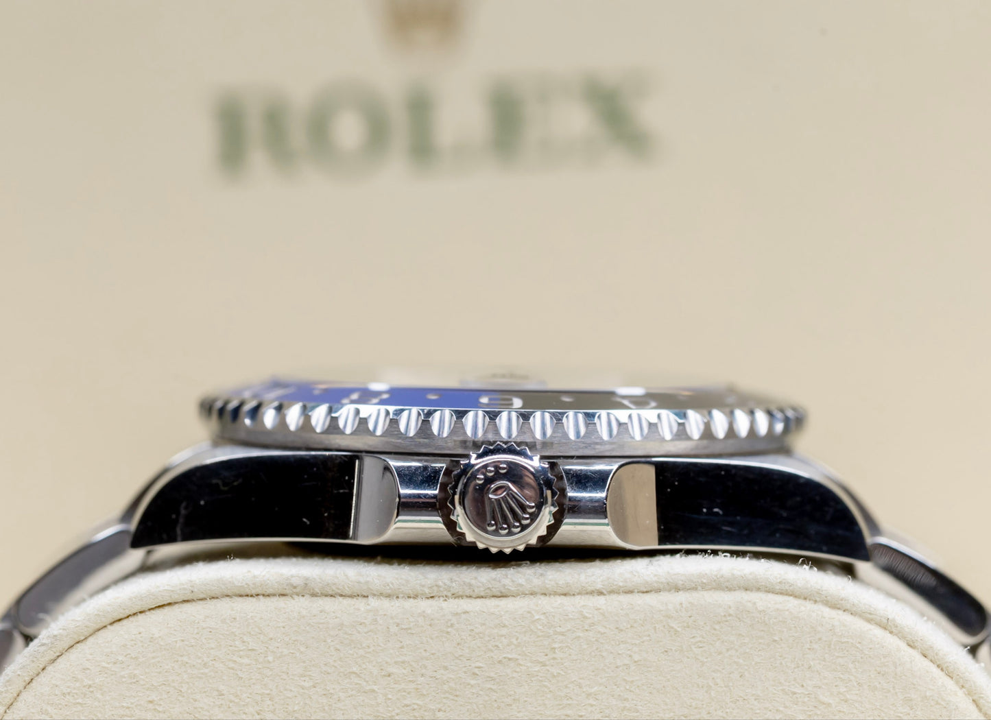 2021 Rolex GMT-Master II Batman showcasing the crown and two-tone bezel against a Rolex backdrop.