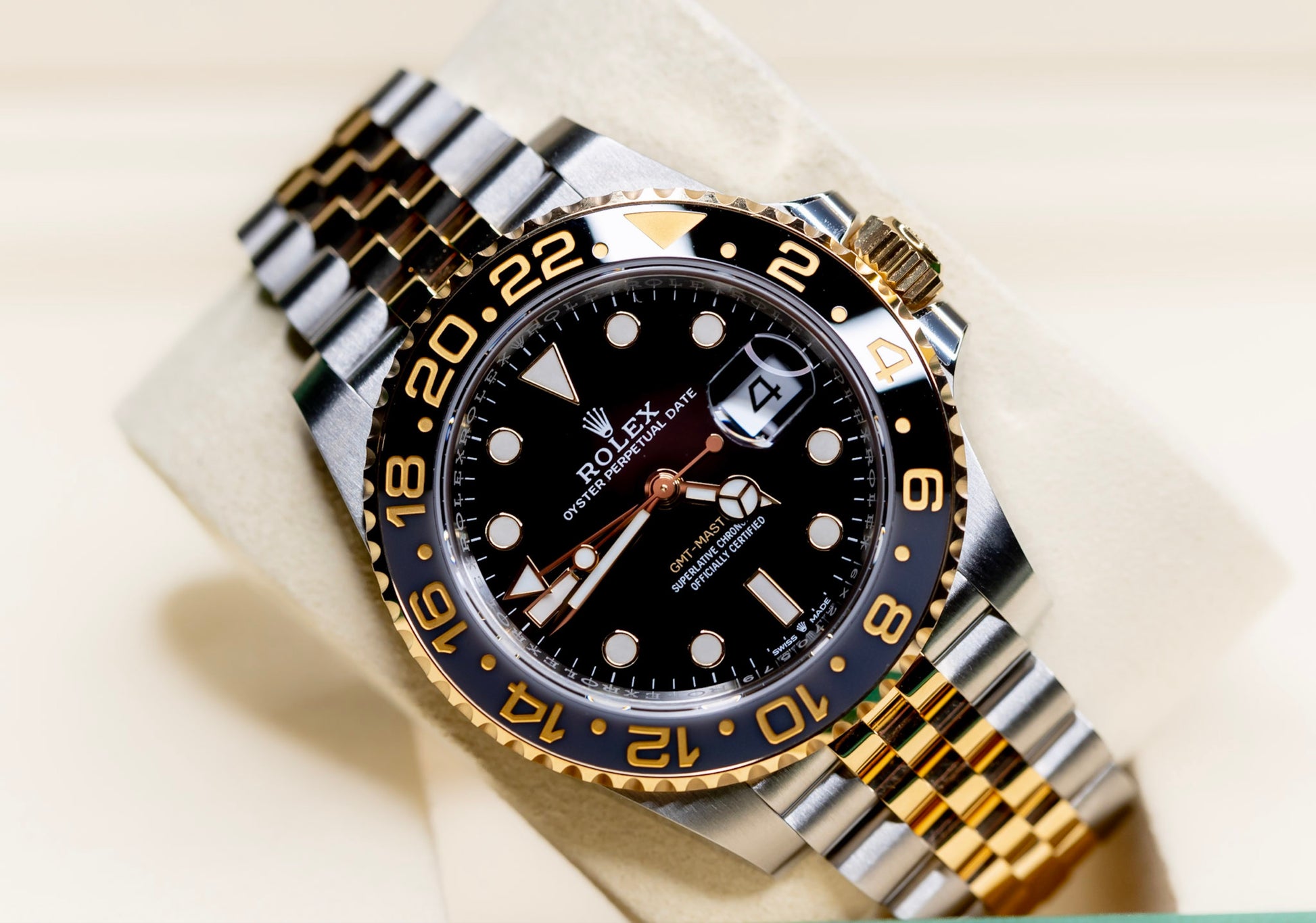 2026 Rolex GMT-Master II Zombie BNIB full set with black dial and gold accents displayed on a stand.