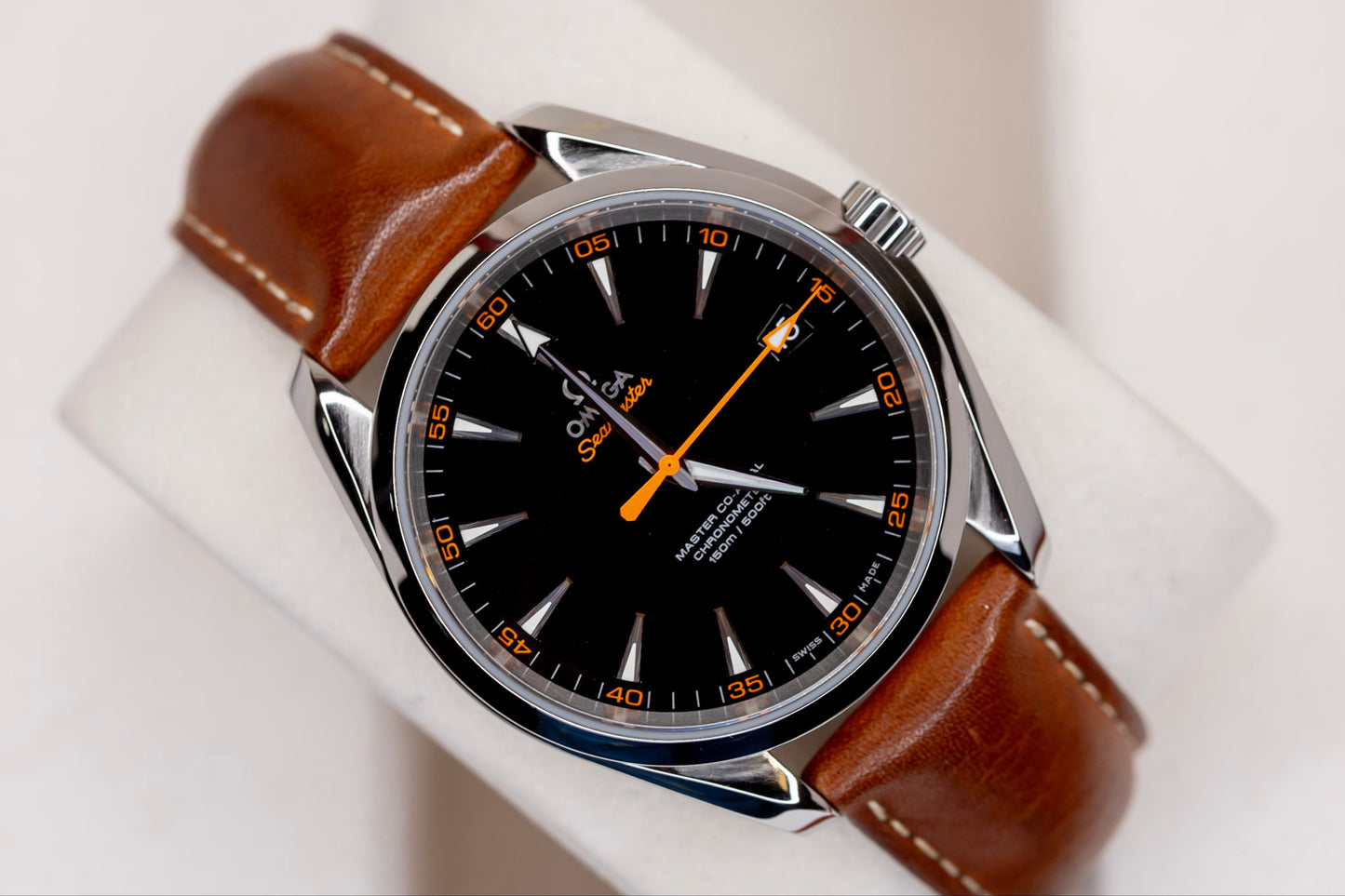 Omega Seamaster Aqua Terra 150M watch with black dial and brown leather strap on display