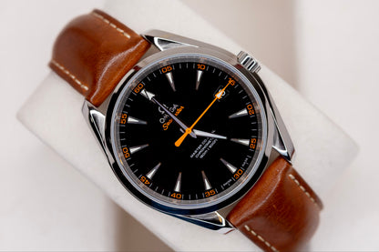 Omega Seamaster Aqua Terra 150M watch with black dial and brown leather strap on display