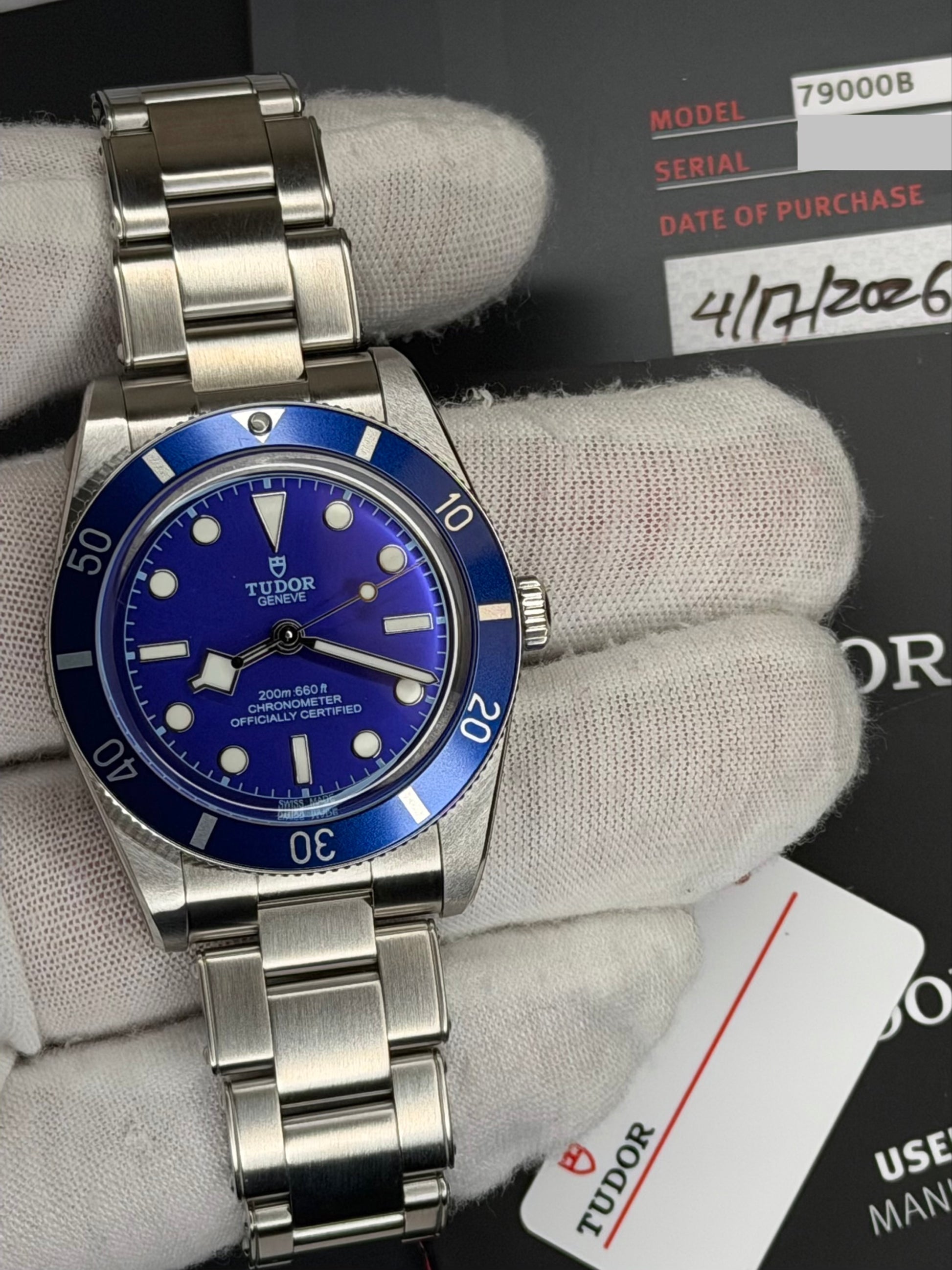 2026 Tudor Black Bay watch showcased with a blue dial, featuring original box and papers, and steel bracelet.