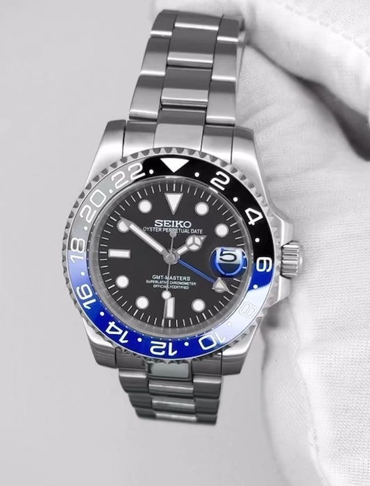 Seiko GMT-Master Batman Automatic Watch showcasing blue and black bezel, stainless steel strap, and intricate dial details.